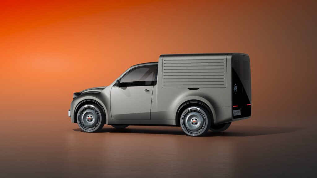 Seitenansicht des grauen Citroën 2CV Fourgonnette Concept mit geripptem Kastenaufbau und schwarzer Heckpartie vor orangefarbenem Hintergrund